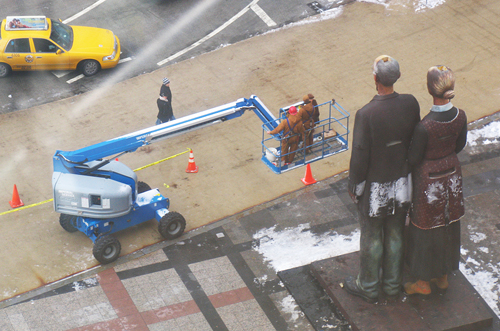 Workers install Johnson's God Bless America in Pioneer Court